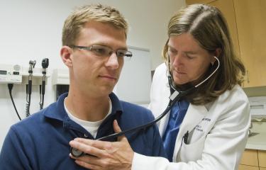 Doctor listening to heartbeat