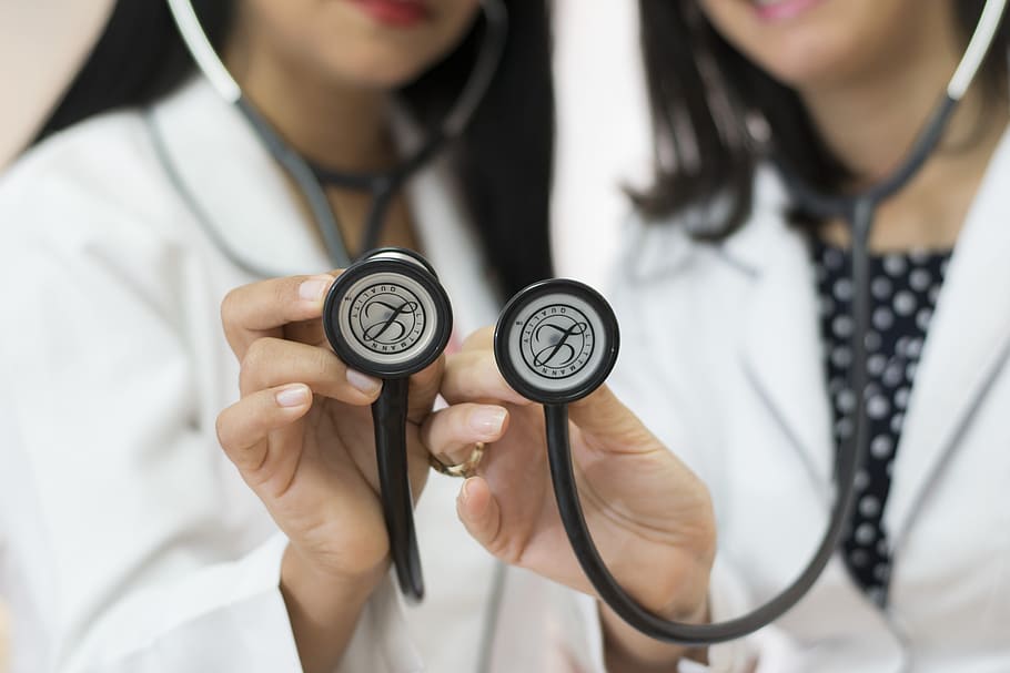 Doctors holding up stethoscopes