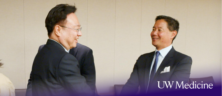 Dr. Eugene Yang, right, greets Cho Kyoo-hong, South Korea’s minister of health and welfare, in Seattle on Aug. 4.